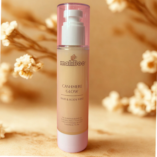 Maliboo Cashmere Glow Hair and Body Mist bottle on soft neutral fabric. Vegan, cruelty-free mist with warm cashmere and vanilla scent.