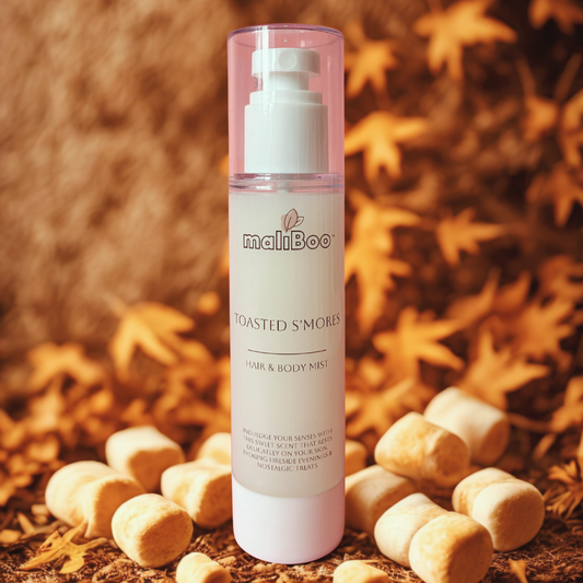 Maliboo Toasted S’mores Hair and Body Mist bottle styled with marshmallows and cocoa tones. Vegan, cruelty-free mist with sweet, cozy scent.